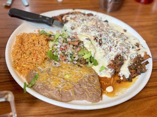 Choripollo. Grilled marinated chicken breasts, smothered in white queso and chorizo. Pico, rice, beans & tortillas.
