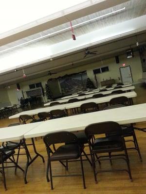 Community room looking toward stage. There are smaller rooms which include card rooms and pool rooms as well as meeting space.
