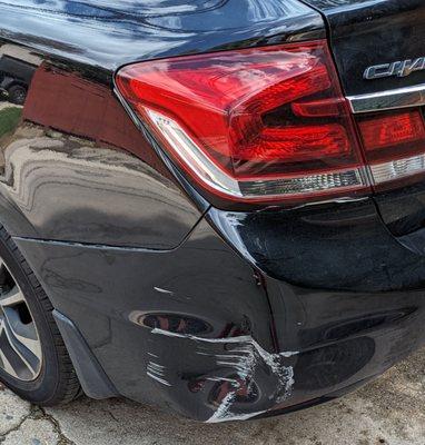 This is the dent before the repair. A decent size scratch with a dent , the bumper was pulling away from the car.