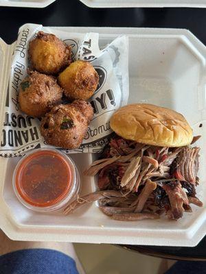 Brisket sandwich and hush puppies