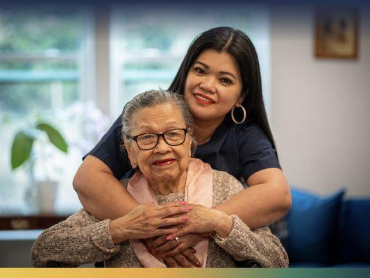 Vivid Life Home Care caregiver hugging a client