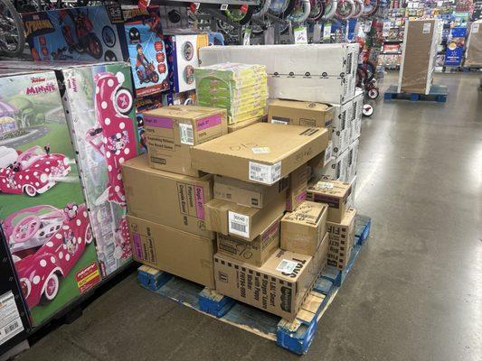 Pallet left on the floor. Employees, "coaches" say customers can't look through boxes on the Floor but they'll leave the pallets out