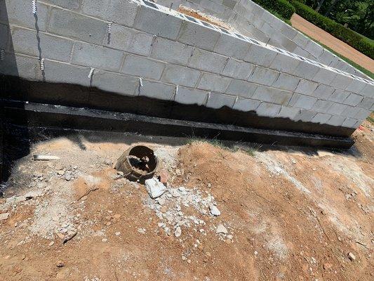 Sealing walls for a new construction home. Brockets will start when membrane dries.
