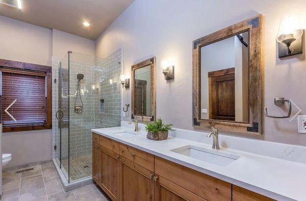 Expertly crafted bathroom remodel with precise wood detailing, flawless dual vanity, and a sleek glass shower. Premium workmanship in Bend.