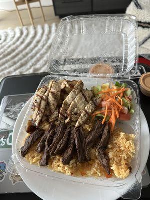 Steak an chicken half and half plate with rice and salad Can't forget the munchi sauce!