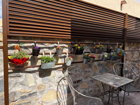 Louvre fence with hanging planter rails.