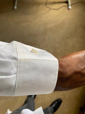 Shirt sleeve is burnt or dirty.