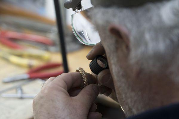 In-house Jeweler inspecting a gold ring.