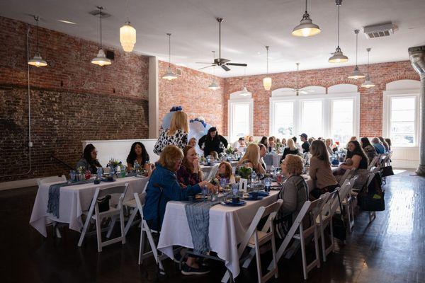 A wider view of my event, the natural lighting and family-style table set-up.