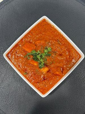 paneer simmered in a rich creamy tomato- butter gravy-delicately spiced and finished with a touch of cream