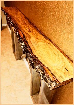 Live edge console table with a glass-like, high gloss finish.