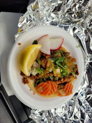 Taco: chicken, beef or pork. The pork was delicious. Includes cilantro & onions, radishes & lime wedge. Friendly service too!