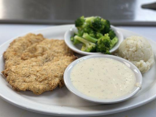 Chicken fried chicken mash potatoes, broccoli and creamy gravy