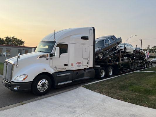 Extra Mile Transport company truck loaded with customer cars