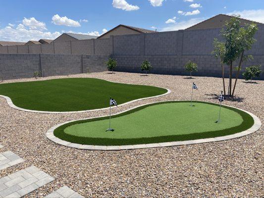 Backyard putting green with a curved turf lawn and paver border -- fun, low-maintenance, and perfect for Arizona living.