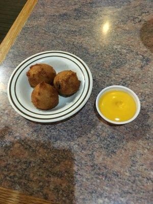 Every diner gets a comped order of hush puppies and sauce. Lagniappe!!