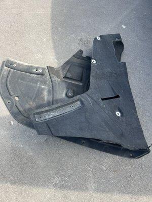 Lower engine cover that they didn't put pack on correctly.