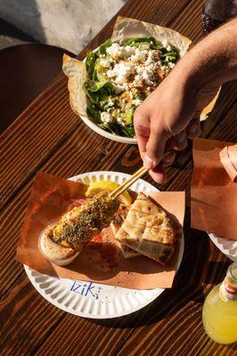 Chicken skewer on a plate, Spanakopita salad