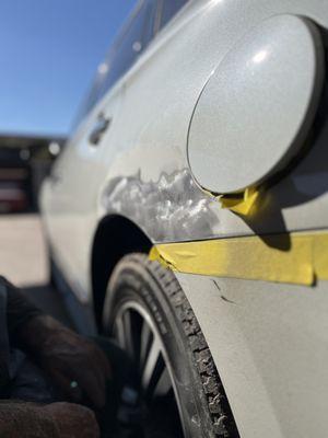 Dent on lexus which is sanded to bare metal and popped back into place.