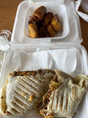 Latino Burrito with steak (partially eaten) and a side of plantains (one eaten).
