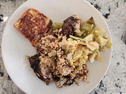 Jerk chicken, rice and peas, cabbage, and macaroni and cheese. Slice of grilled homemade rum cake on the side.