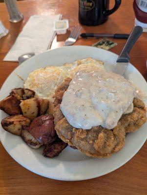 Eggs over easy chicken, fried steak, and some delicious home fries!!