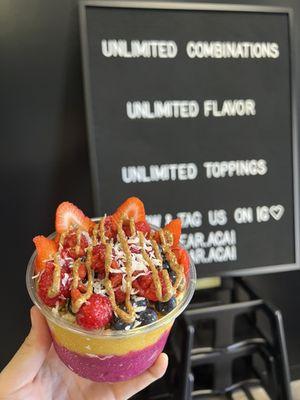 pitaya and mango base strawberries, blueberries, raspberries sweetened coconut almond butter goji berries