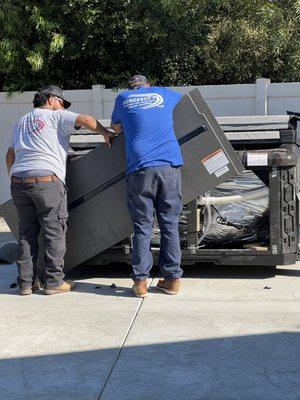 Delivery team coordinating with electrician