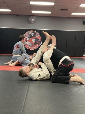 Drilling Arm bars in BJJ class to warm up