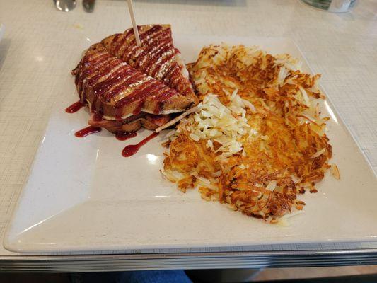 Gluten free monte crisco sandwich with a side of hash browns.