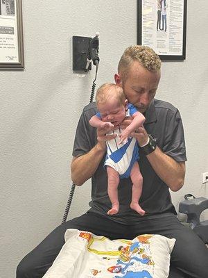 another cholicy baby getting tension released in his back, so he can poop. mom had to change his outfit before they left.