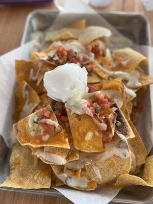 Nachos after pouring a cup of queso on top (barely anything on top)