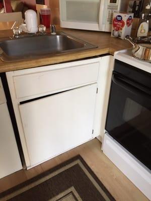 Kitchen sink detached from cabinet (gaping open hole)