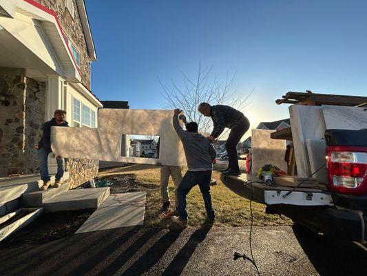 Our experienced team carefully unloading and transporting premium stone slabs for installation.