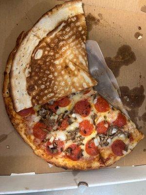 The pizza i Bought showing the top view and the weird sponge like crust. Which I really believe it's pre made frozen pizza crust 