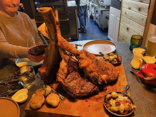 OMG!!! Perfectly cooked tomahawk steaks, roasted heads of garlic, bacon, infused, brussels sprouts, and harissa garlic, mashed potatoes