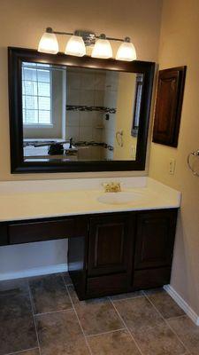 The beauty of custom cabinets in your bathroom and wood framed mirrors to match.