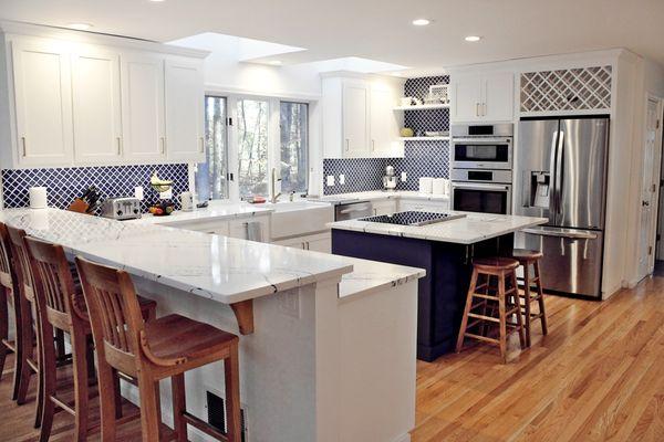 Revamping the space with a bold blue touch, complemented by a stylish wine rack and open shelving that brighten the room beautifully!