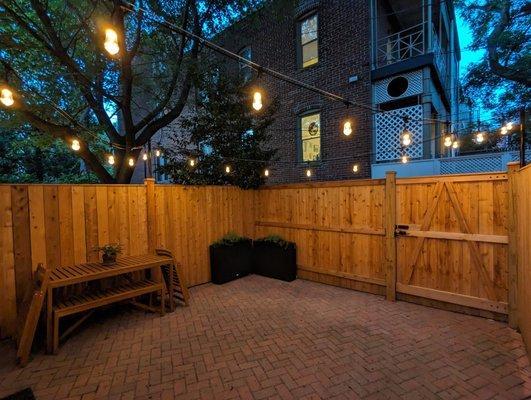 Part of our new fence by Mill to You, with poles that they installed for string lights.