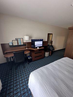 Desk area with full length mirror and coat hook.