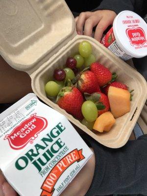 Fruits from the salad bar with yogurt and OJ