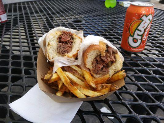 Slice beef sandwich with fries and a drink for the day