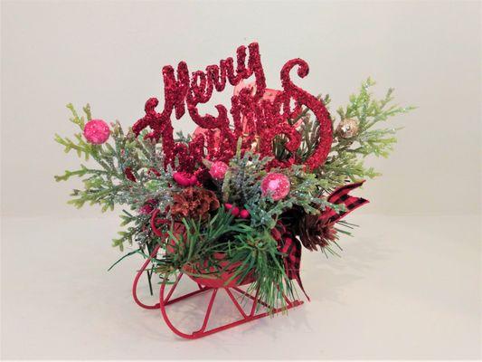 Mini red sleigh with Christmas trim.
