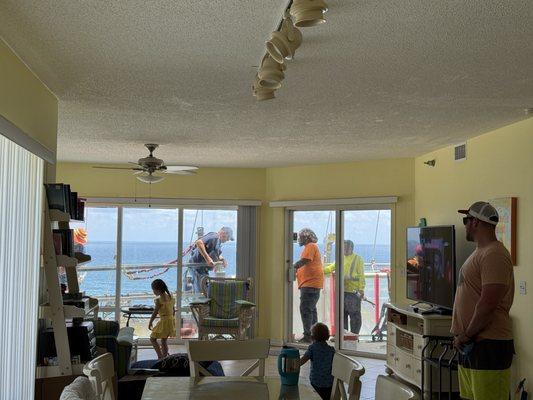 Workers outside on the balcony and outside the windows on the left. Unable to use balcony M-F 8-5