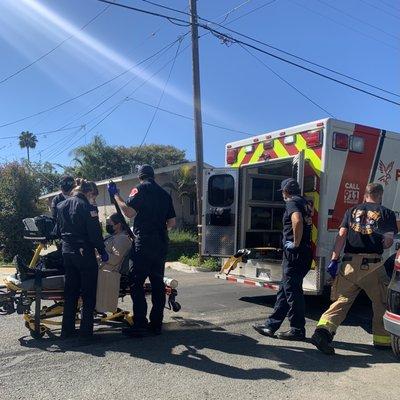 Both firemen team and EMTs ambulance team taking care of the patient.