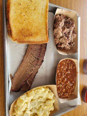 Pulled pork and brisket with mac and cheese and baked beans and Texas toast