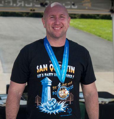 The boss sporting our team shirt and medal for the Special Olympics fundraiser run and polar plunge.