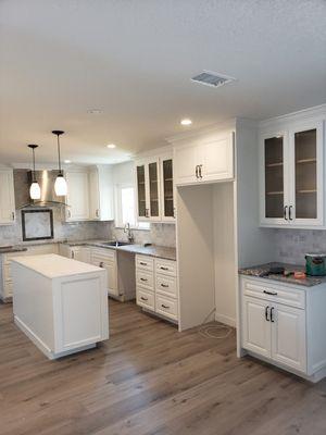 Kitchen Cabinet Refinish. Conversation of natural stained wood cabinets to new solid White Lacquer