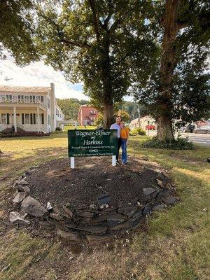 New owners in front of the new Funeral Home sign.