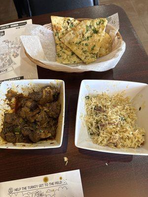 Goat curry, garlic naan, ghee rice with onions and cashews and raisins (not on the menu)